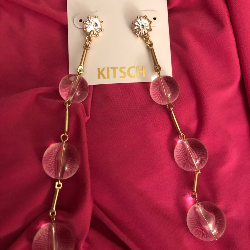 Kitsch clear plastic marble dangling earrings.